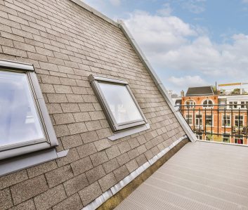 Bright brick balcony with metal railings and door