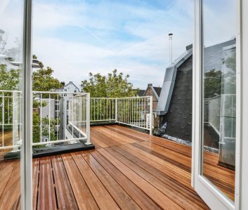 Rooftop exterior with delightful wood flooring and white railings